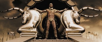 Xerxes (RODRIGO SANTORO), the Persian king who claims to be a god, stands atop his elaborate golden litter in Warner Bros.